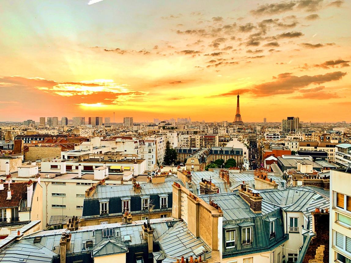 a view of Paris from the rooftop during sunset