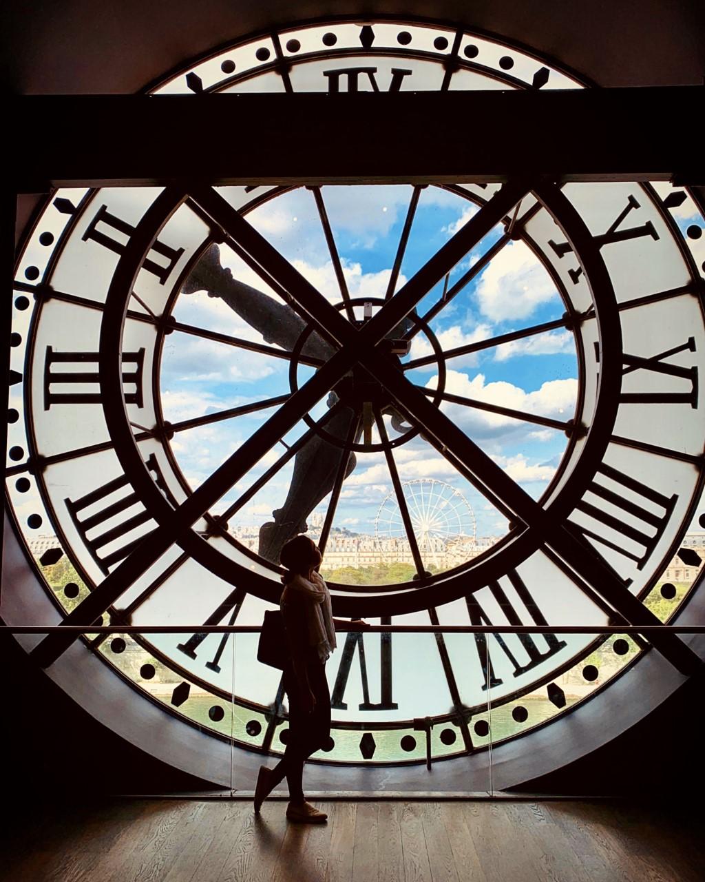 a student's silhouette behind a clock tower at Musee D'orsay