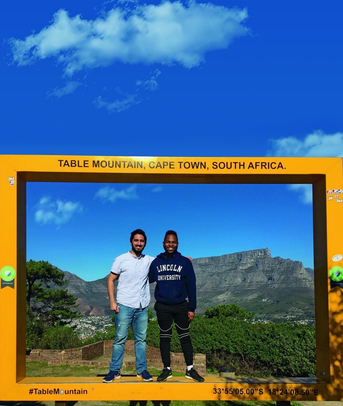 Two Internship students standing in front of Table Mountain in Cape Town
