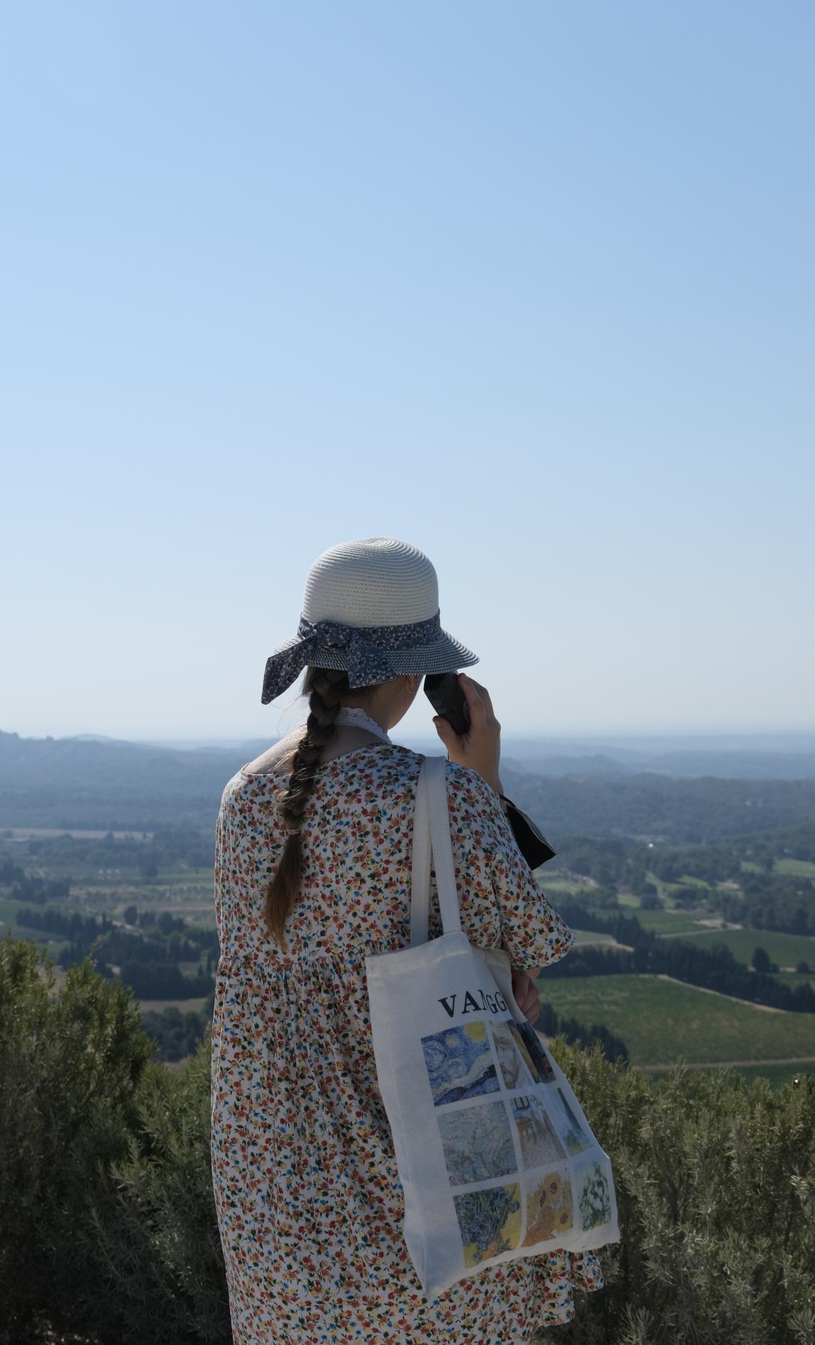 A student looks out over the green landscape of Beaux de Provence, France.