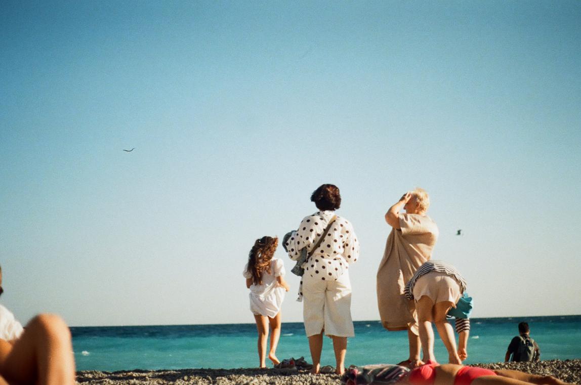 A family stands on the beach in Nice, France.