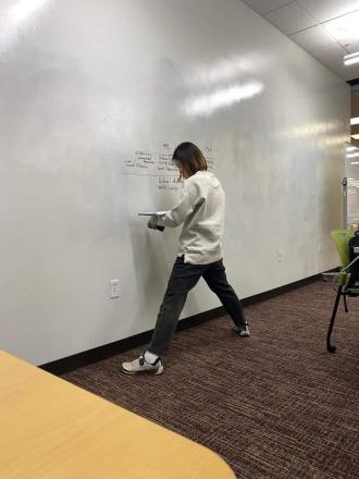 A student writes on a white board to study