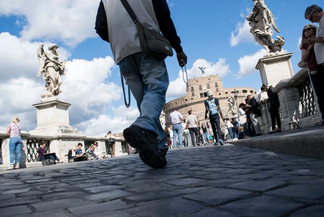 an artistic shot of people's feet as they walk toward Castel Sant'Angelo