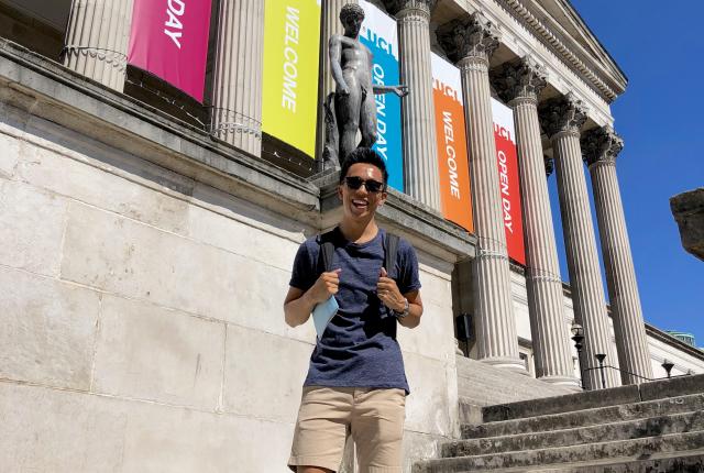 a student standing on the steps of University College London
