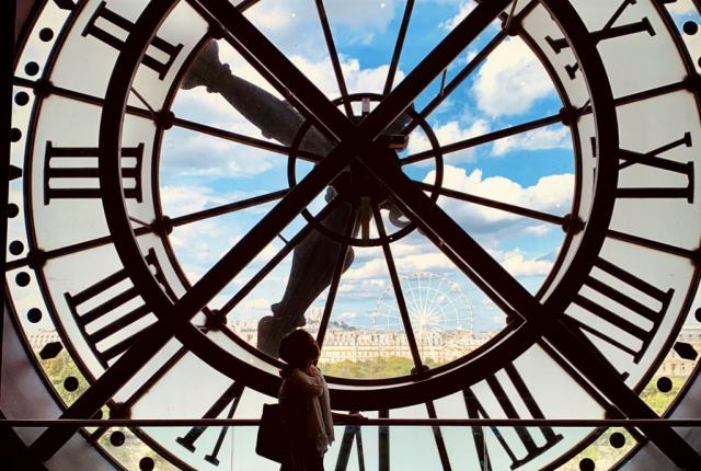 a student's silhouette behind a clock tower at Musee D'orsay
