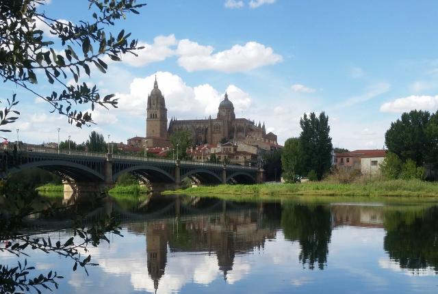 a stone bridge across the Tormes River to a building