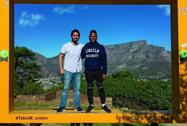 Two Internship students standing in front of Table Mountain in Cape Town