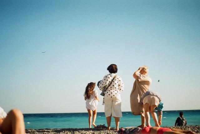 A family stands on the beach in Nice, France.