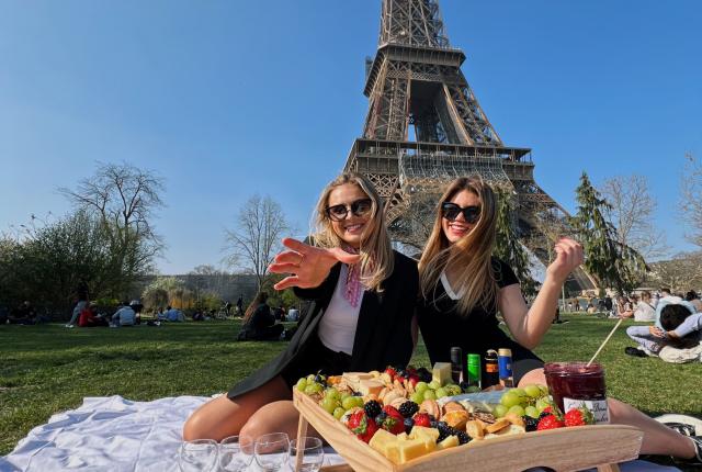 Two students having a picnic at the Eiffel Tower in Paris, France