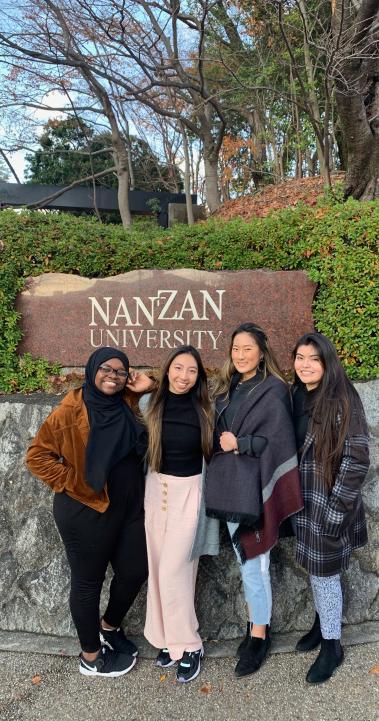 students pose for a photo in front of the Nanzan University sign in Nagoya
