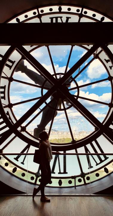 a student's silhouette behind a clock tower at Musee D'orsay