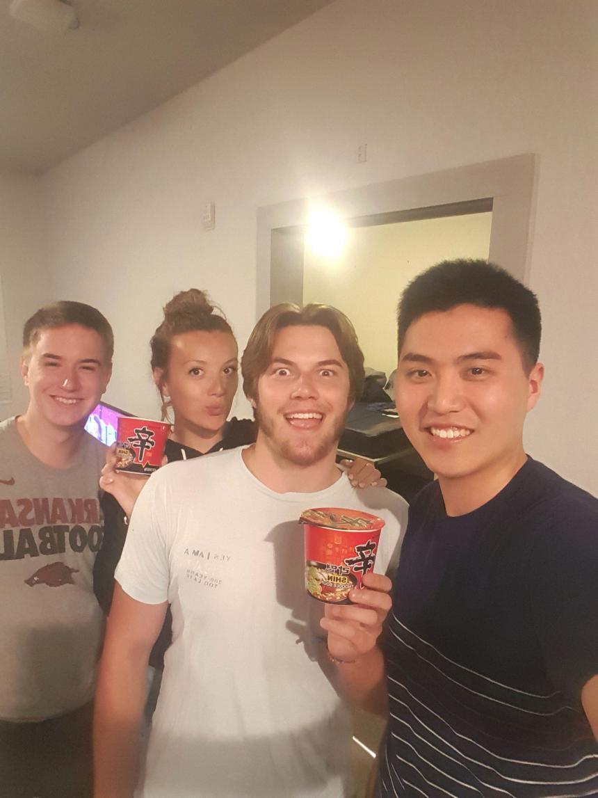SAF student Kihwan Kim shares his Korean noodles with friends at University of Arkansas