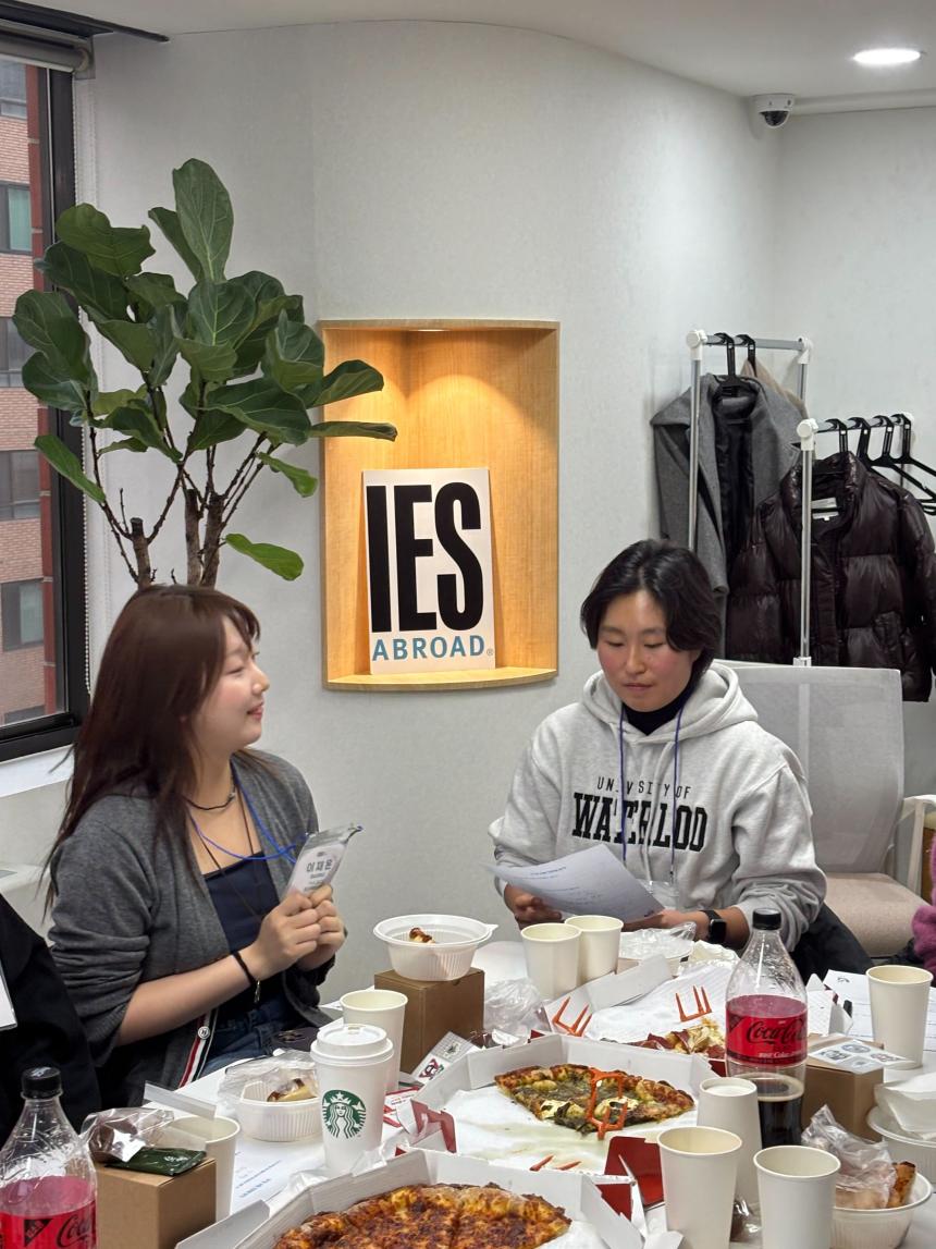 SAF Korea student who studied at the University of Waterloo presents at a networking event in front of an IES Abroad sign.