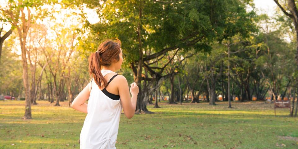 Woman running in a park on a sunny day