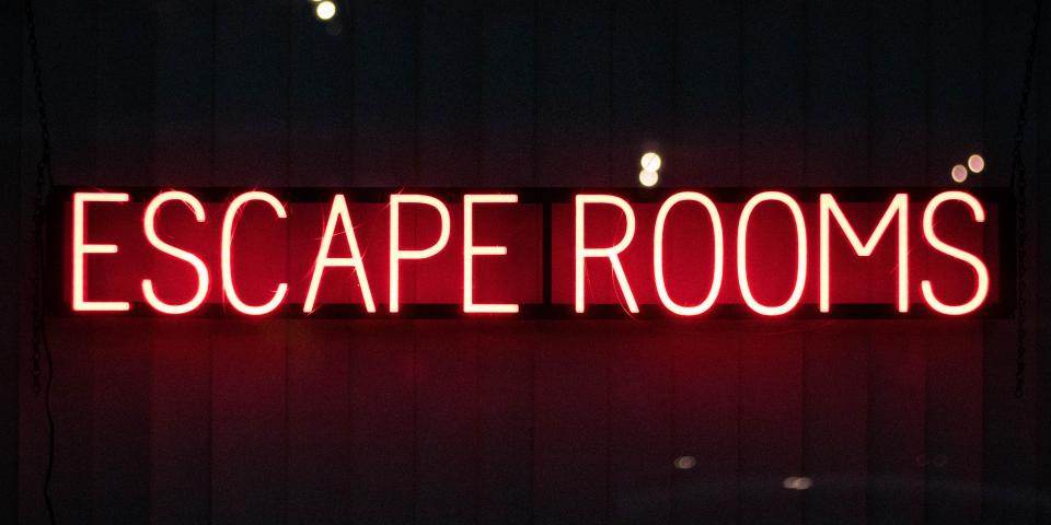 a neon sign that says escape rooms