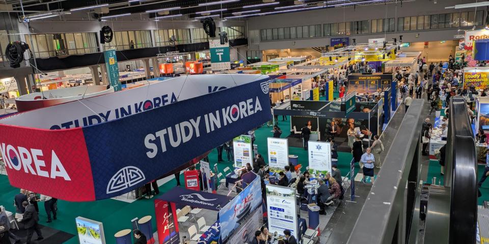 Crowds visiting study abroad booths in the exhibition hall at EAIE 2025.